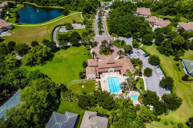 an aerial view of a house with a yard and lake view
