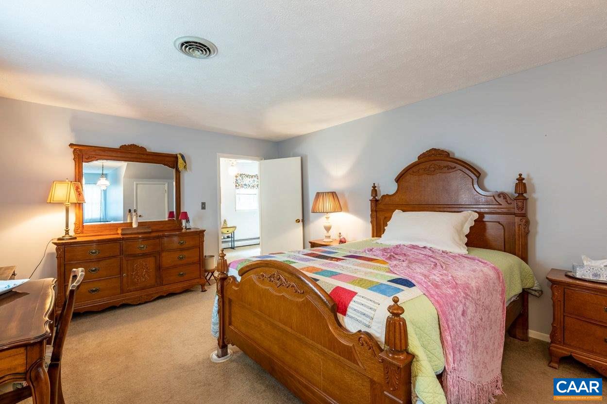 1830 Hunters Lodge Road Palmyra, VA 22963 - Photo 14 of 32 a bedroom with a bed and a dresser