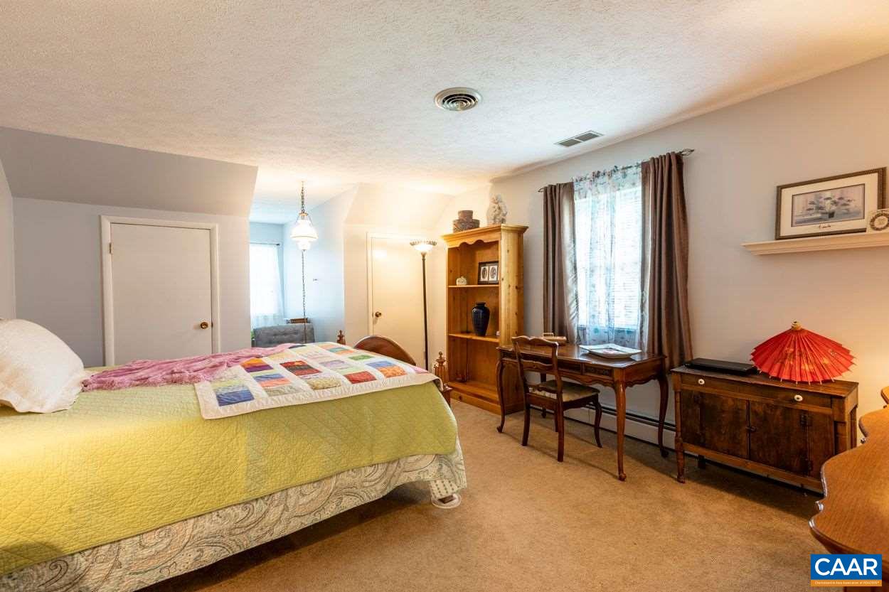 1830 Hunters Lodge Road Palmyra, VA 22963 - Photo 15 of 32 a bedroom with a bed and wooden floor