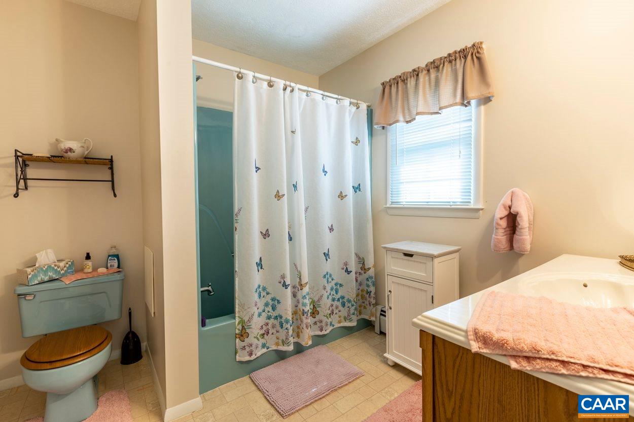 1830 Hunters Lodge Road Palmyra, VA 22963 - Photo 21 of 32 a bathroom with a sink toilet and shower