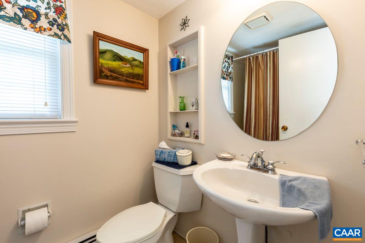 1830 Hunters Lodge Road Palmyra, VA 22963 - Photo 24 of 32 a bathroom with a toilet sink and mirror