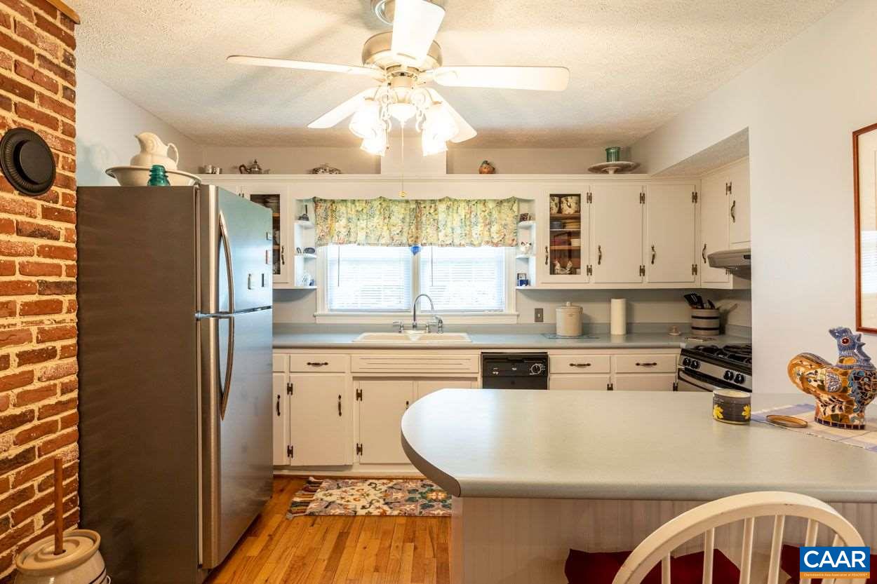 1830 Hunters Lodge Road Palmyra, VA 22963 - Photo 8 of 32 a kitchen with stainless steel appliances a stove a refrigerator and white cabinets