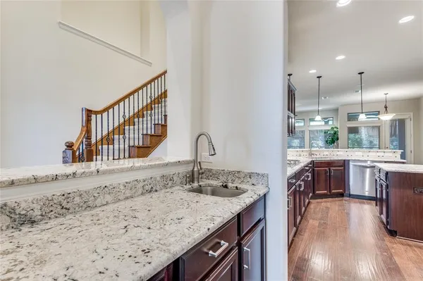 a spacious bathroom with a granite countertop sink a mirror and bathtub