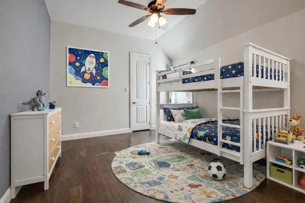 a bedroom with furniture and a wooden floor