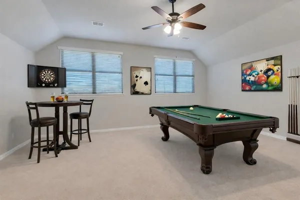 a room with furniture pool table and window