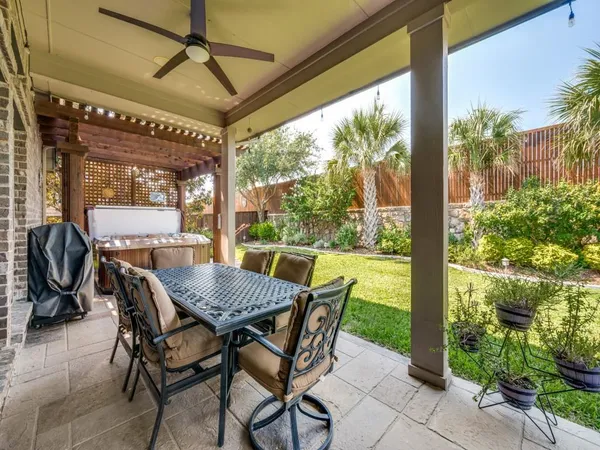 a view of an outdoor dining space with a table and chairs