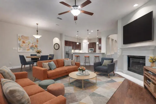 a living room with furniture fireplace and a flat screen tv