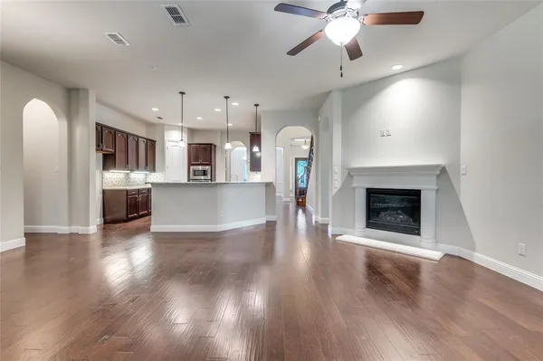 a view of a kitchen with a sink a kitchen a refrigerator and a fireplace