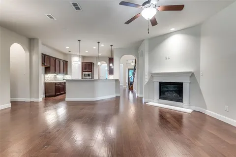 a view of a kitchen with a sink a kitchen a refrigerator and a fireplace