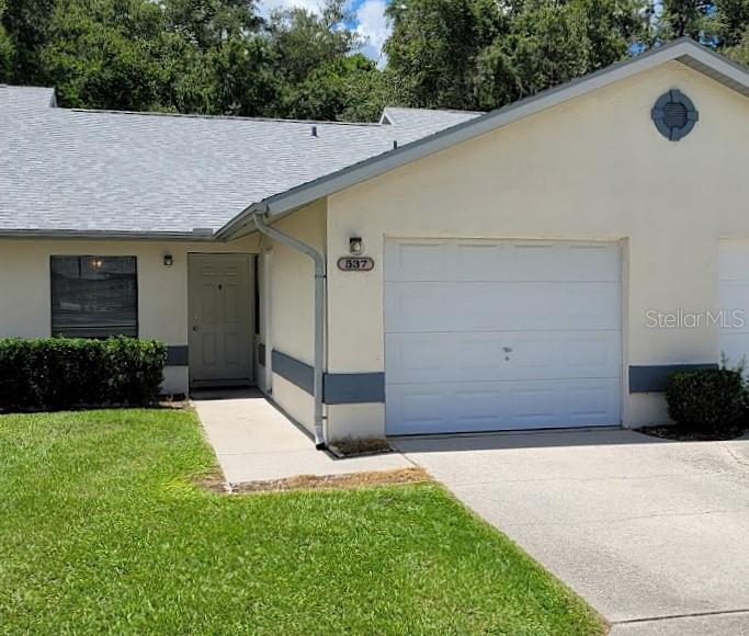 537 Crossleaf Lane Inverness, FL 34453 - Photo 1 of 1 a backyard of a house with plants and trees