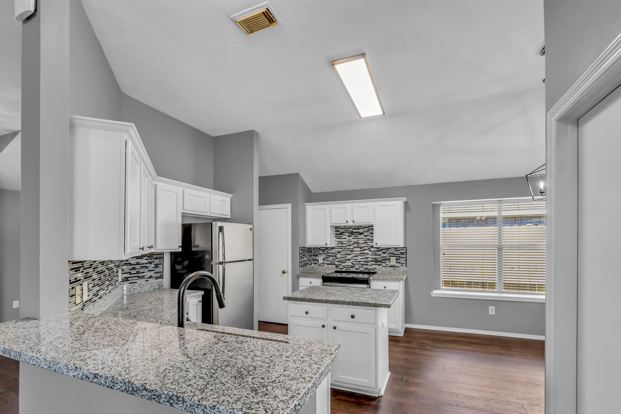 15503 West Little York Road Houston, TX 77084 - Photo 6 of 22 a kitchen with stainless steel appliances kitchen island granite countertop a sink and a white cabinets