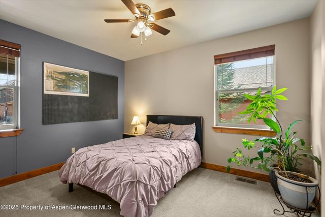 a bedroom with a bed and a potted plant