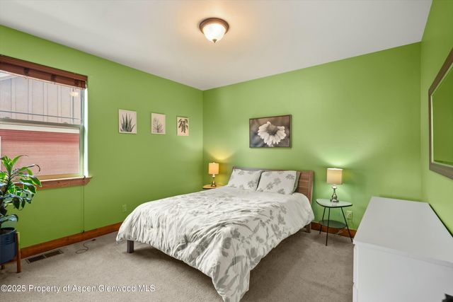 a bedroom with a bed and a dresser