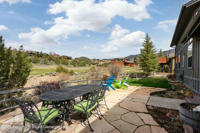 a view of swimming pool with outdoor seating and city view