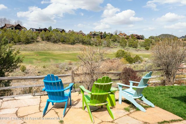 a view of a lake with table and chairs