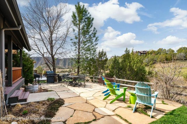 a view of backyard with a table and chairs