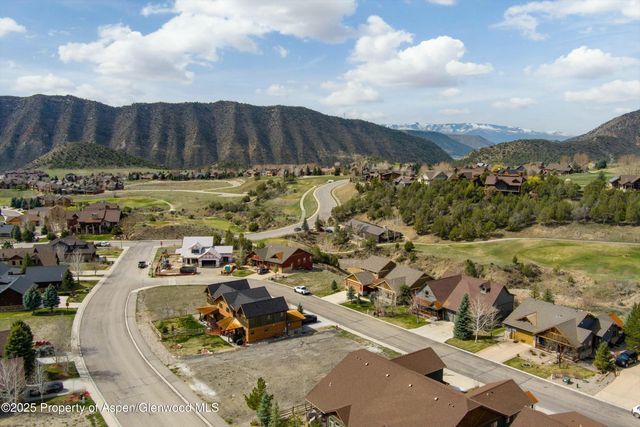 an aerial view of a house with a yard