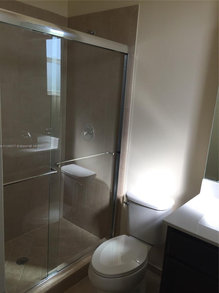 134 Northeast 28th Terrace, Unit 4 Homestead, FL 33033 - Photo 12 of 33 a bathroom with a toilet and a shower