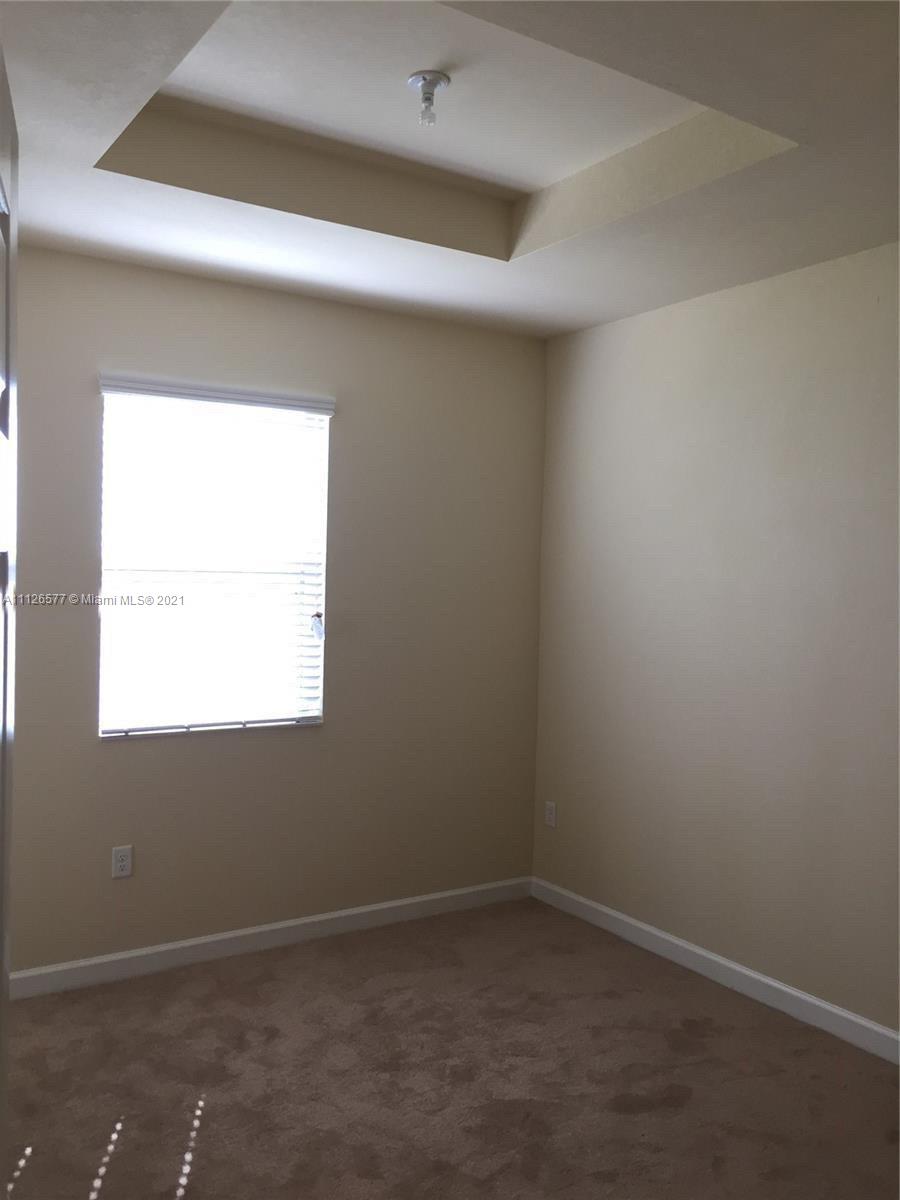 134 Northeast 28th Terrace, Unit 4 Homestead, FL 33033 - Photo 13 of 33 an empty room with a window