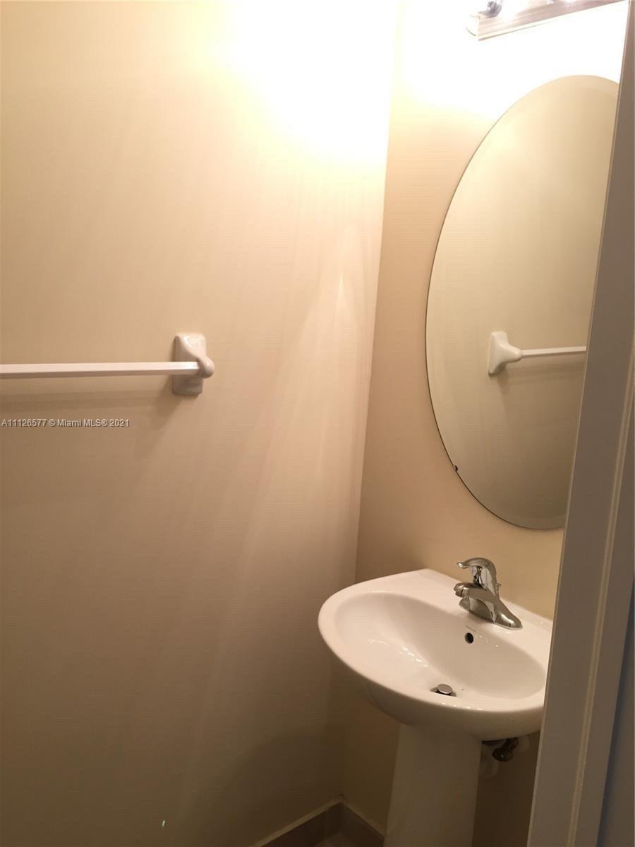 134 Northeast 28th Terrace, Unit 4 Homestead, FL 33033 - Photo 15 of 33 a bathroom with a sink and mirror