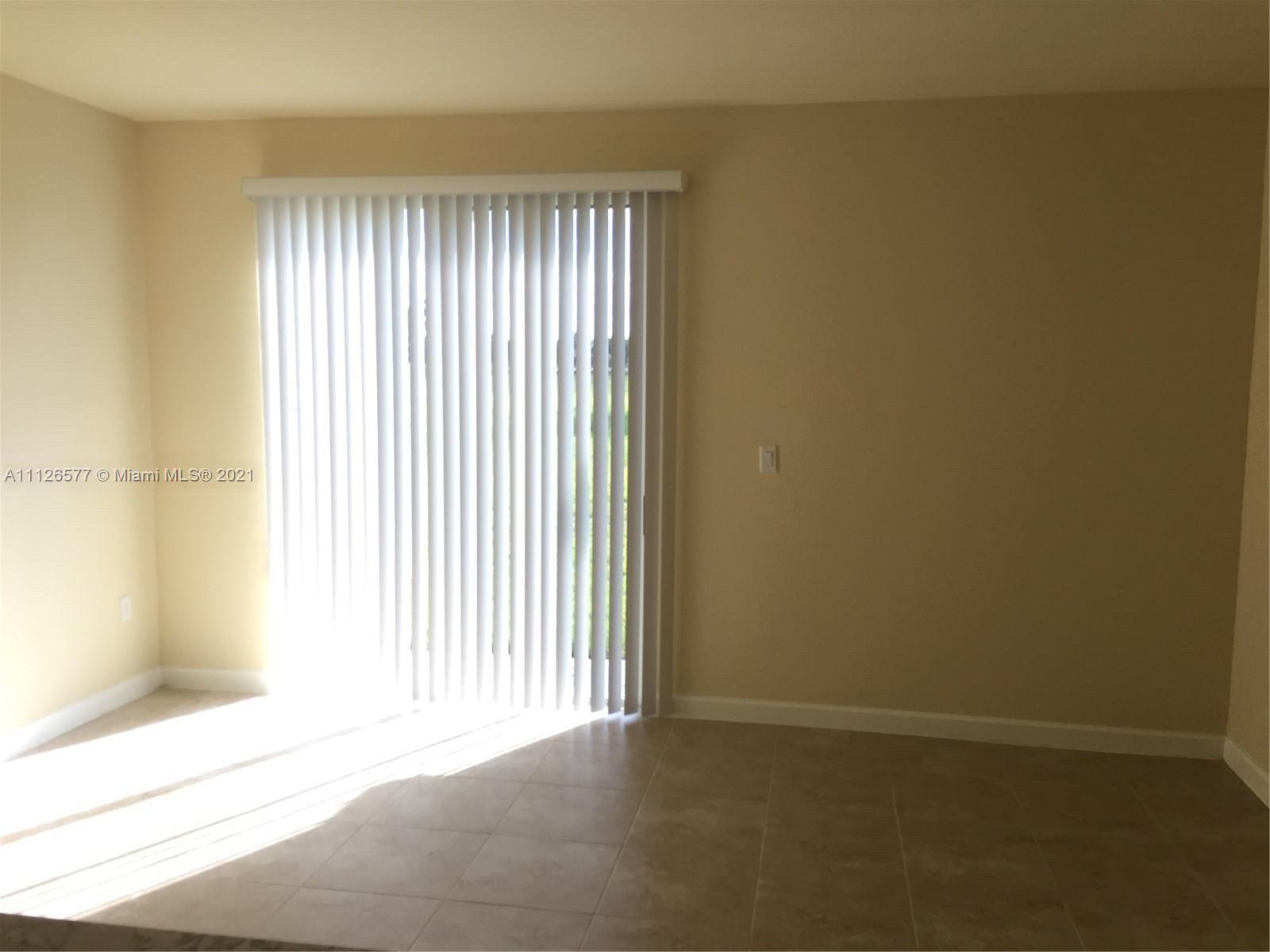 134 Northeast 28th Terrace, Unit 4 Homestead, FL 33033 - Photo 17 of 33 an empty room with a window