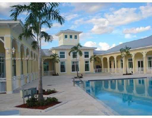 134 Northeast 28th Terrace, Unit 4 Homestead, FL 33033 - Photo 28 of 33 a front view of a building with a garden