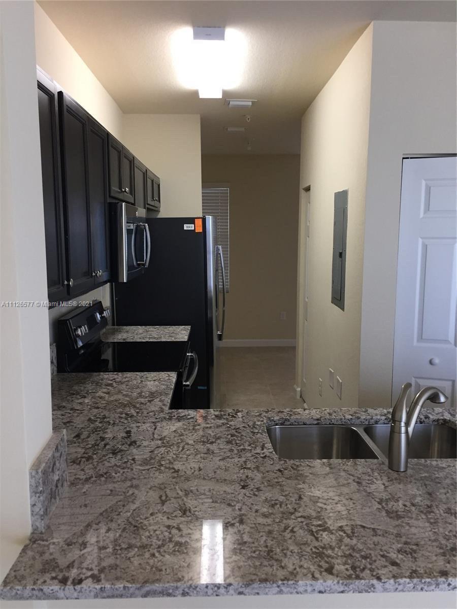 134 Northeast 28th Terrace, Unit 4 Homestead, FL 33033 - Photo 6 of 33 a view of a refrigerator in kitchen