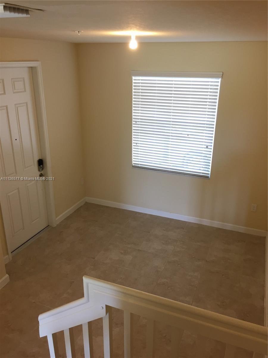 134 Northeast 28th Terrace, Unit 4 Homestead, FL 33033 - Photo 7 of 33 a view of an empty room with a window