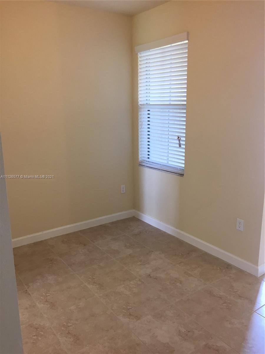 134 Northeast 28th Terrace, Unit 4 Homestead, FL 33033 - Photo 8 of 33 an empty room with a window