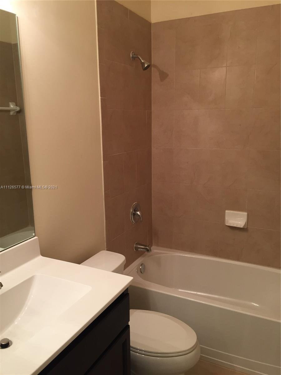 134 Northeast 28th Terrace, Unit 4 Homestead, FL 33033 - Photo 9 of 33 a bathroom with a toilet a sink and a bathtub