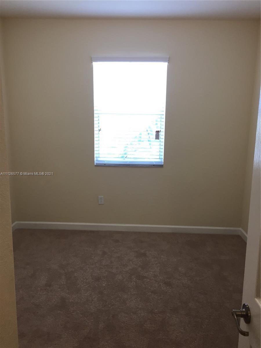 134 Northeast 28th Terrace, Unit 4 Homestead, FL 33033 - Photo 10 of 33 a view of an empty room with a window