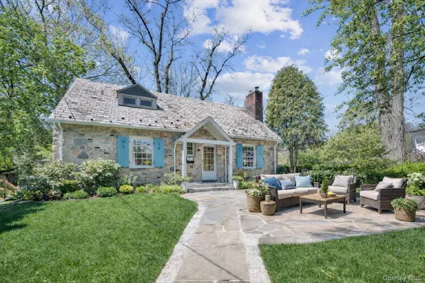 a view of a house with sitting area and garden