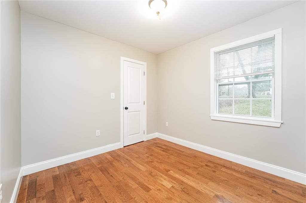 528 Newlin Court Lawrenceville, GA 30046 - Photo 18 of 30 a view of empty room with wooden floor and fan
