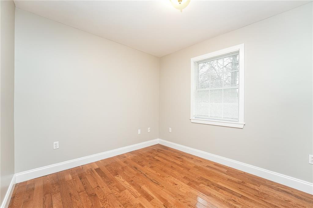 528 Newlin Court Lawrenceville, GA 30046 - Photo 20 of 30 an empty room with wooden floor and windows