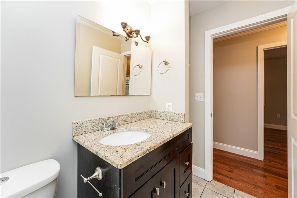 528 Newlin Court Lawrenceville, GA 30046 - Photo 23 of 30 a bathroom with a granite countertop sink toilet and mirror