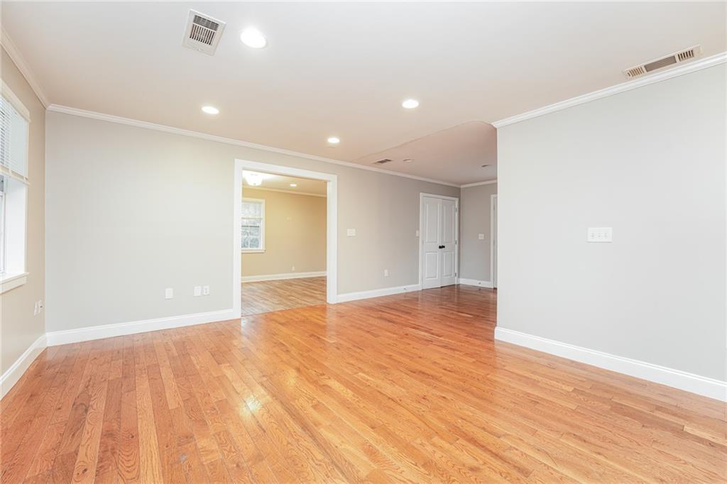 528 Newlin Court Lawrenceville, GA 30046 - Photo 4 of 30 a view of an empty room with wooden floor and a window