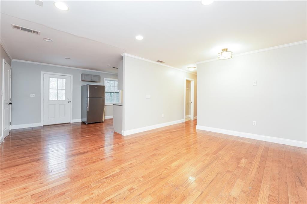 528 Newlin Court Lawrenceville, GA 30046 - Photo 5 of 30 a view of an empty room with window and wooden floor