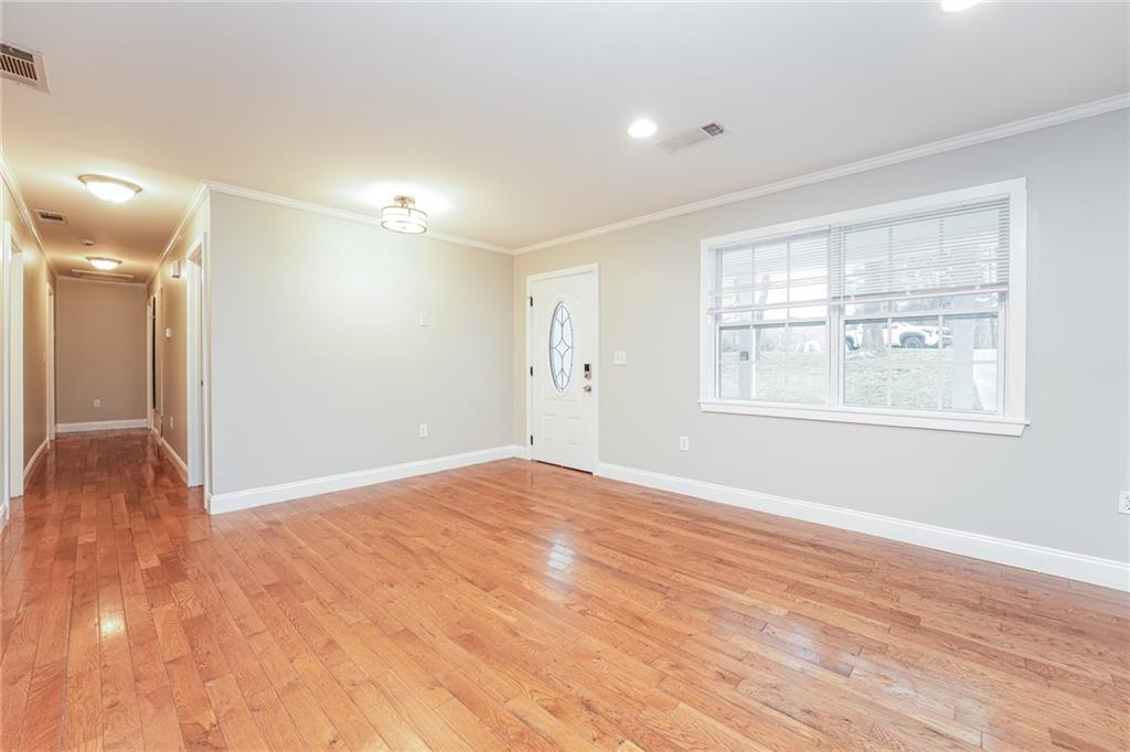 528 Newlin Court Lawrenceville, GA 30046 - Photo 6 of 30 a view of an empty room with wooden floor and a window