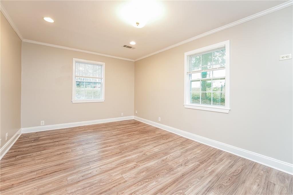 528 Newlin Court Lawrenceville, GA 30046 - Photo 8 of 30 an empty room with wooden floor and windows