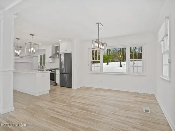 a view of a dining room that has a table and chairs