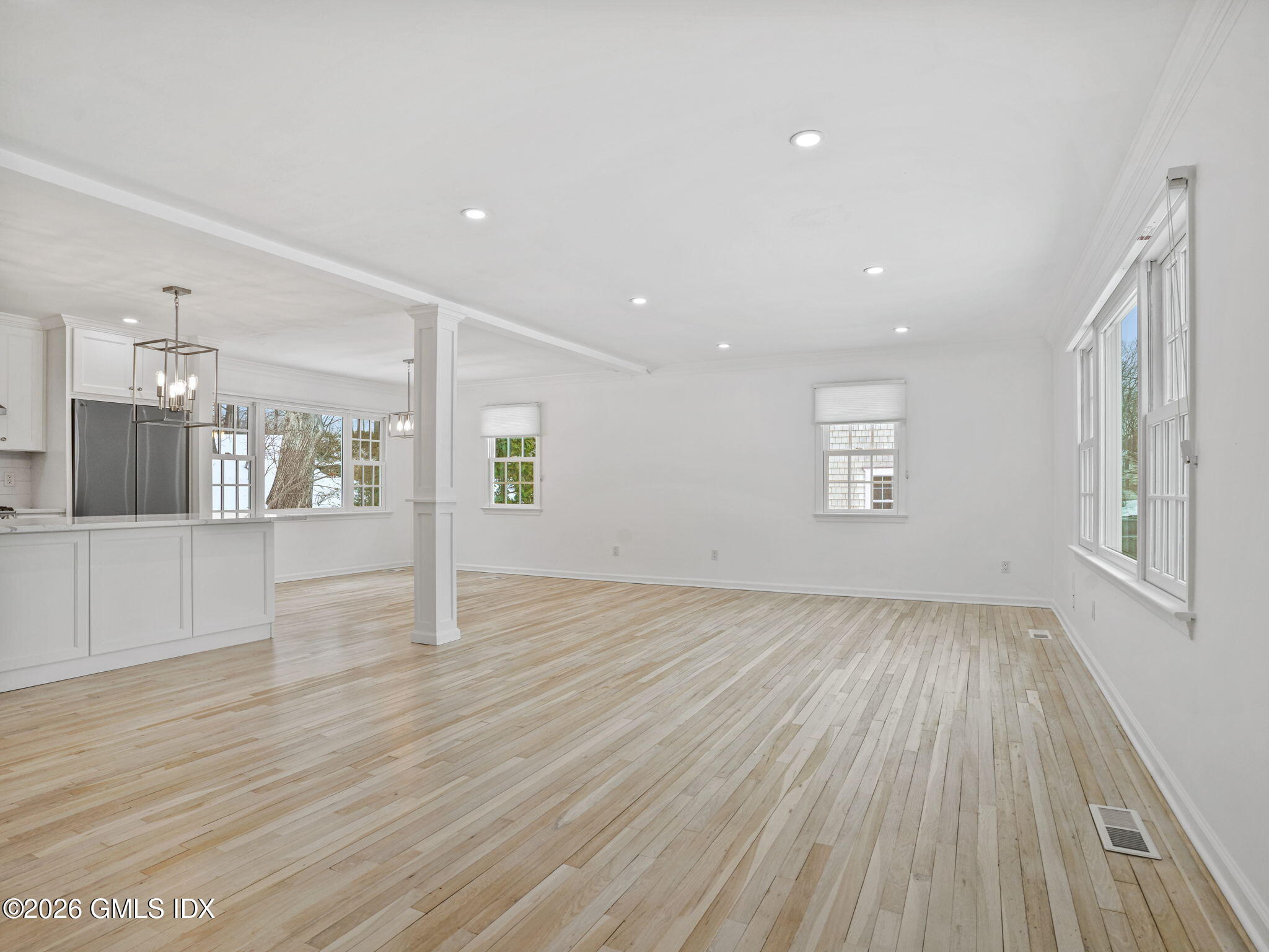104 Hillcrest Park Road Cos Cob, CT 06807 - Photo 4 of 25 a view of an empty room with wooden floor and a window