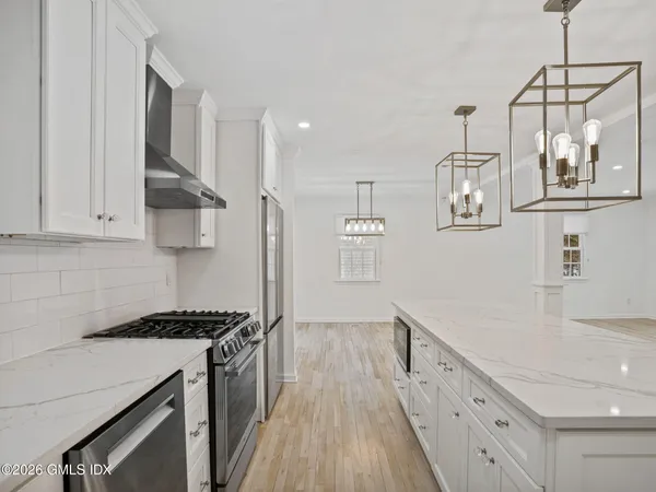 a kitchen with granite countertop a stove and a sink
