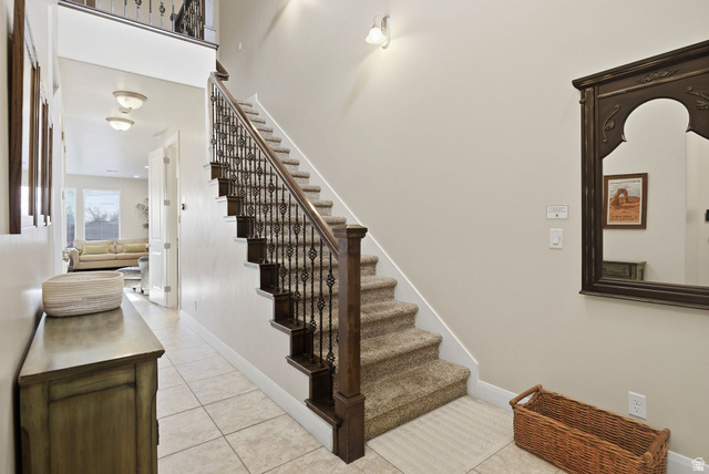 4269 Razor Drive Washington, UT 84780 - Photo 3 of 50 Staircase featuring tile patterned flooring and a towering ceiling