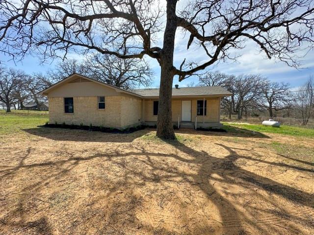 1045 HCR 2124 Loop Whitney, TX 76692 - Photo 1 of 26 a house with a large tree in front of it