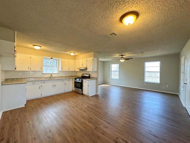 1045 HCR 2124 Loop Whitney, TX 76692 - Photo 11 of 26 an empty room with wooden floor and windows
