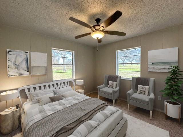 1045 HCR 2124 Loop Whitney, TX 76692 - Photo 14 of 26 a spacious bedroom with a bed and a couch