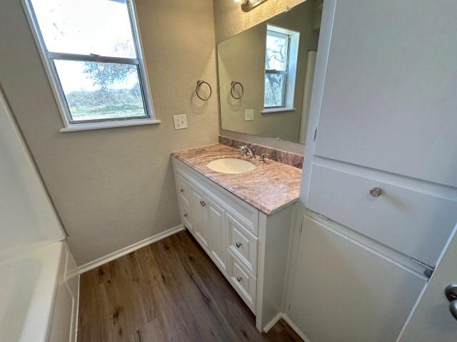 1045 HCR 2124 Loop Whitney, TX 76692 - Photo 18 of 26 a bathroom with a granite countertop sink a vanity and a window