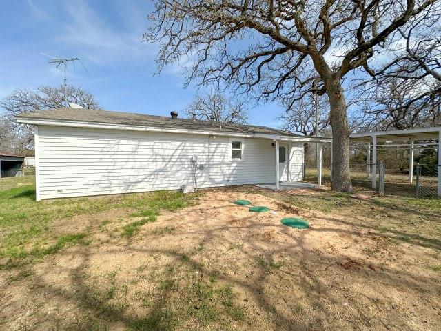 1045 HCR 2124 Loop Whitney, TX 76692 - Photo 20 of 26 a view of a house with a backyard and a tree