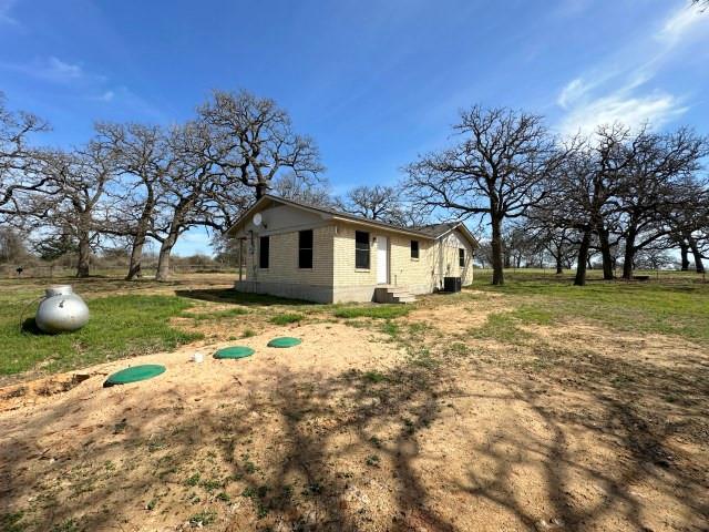 1045 HCR 2124 Loop Whitney, TX 76692 - Photo 2 of 26 a view of a house with backyard and tree
