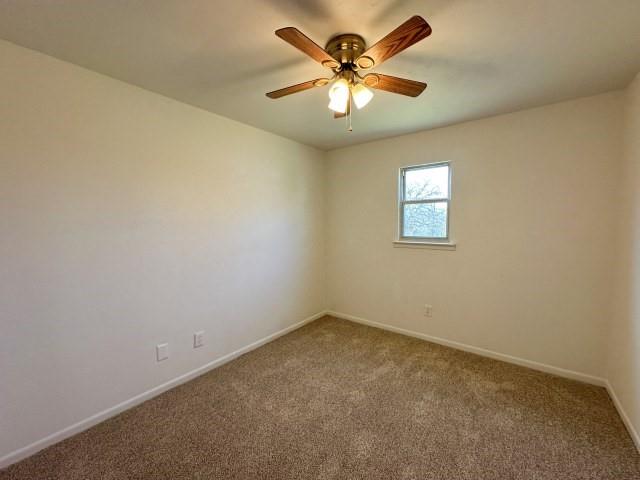 1045 HCR 2124 Loop Whitney, TX 76692 - Photo 26 of 26 an empty room with a chandelier fan and windows